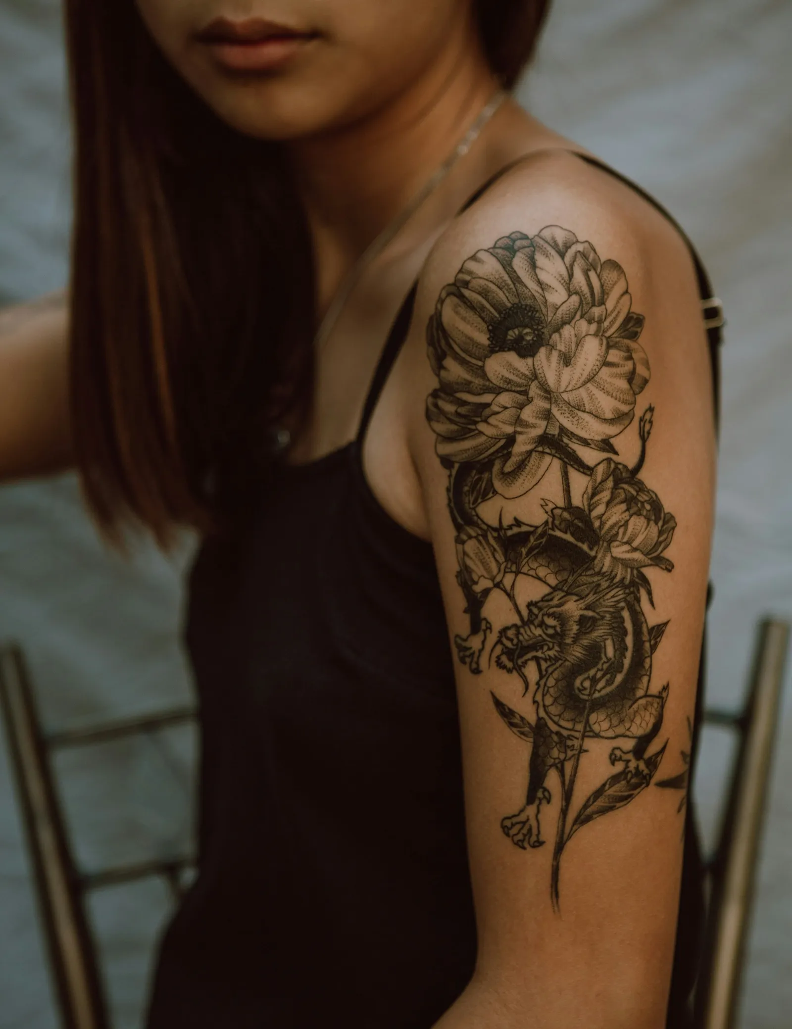 Pieza en brazo: dragón y peonía en blackwork con dotwork
